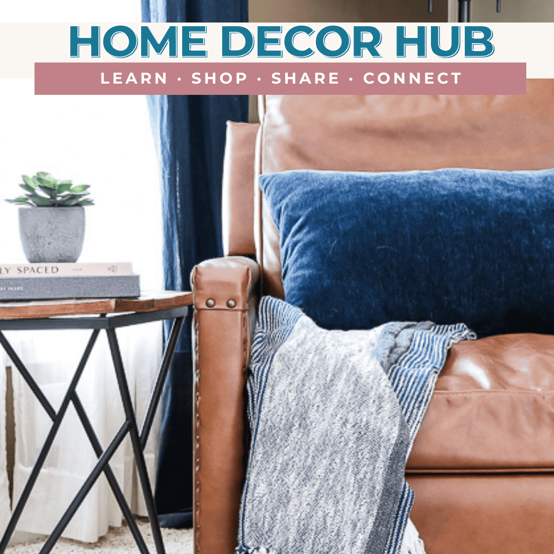 Cozy home interior with a leather armchair, blue cushion, and throw blanket next to a small side table with books and a potted plant. Banner above reads "Home 2024 Decor Hub