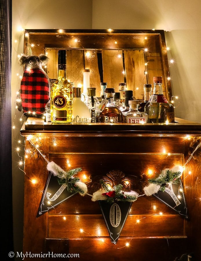 Licor 43 surrounded by holiday lights on a vintage ice chest turned bar cart.