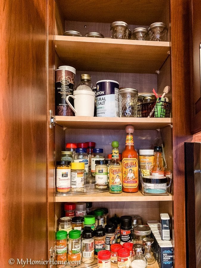 How to organize your kitchen cabinets using clear and simple strategies to tackle kitchen cabinet dysfunction without losing your mind. The spices cabinet before... yikes!