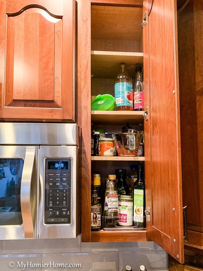 How to organize your kitchen cabinets using clear and simple strategies to tackle kitchen cabinet dysfunction without losing your mind. The oil and miscellaneous cabinet before... yikes!