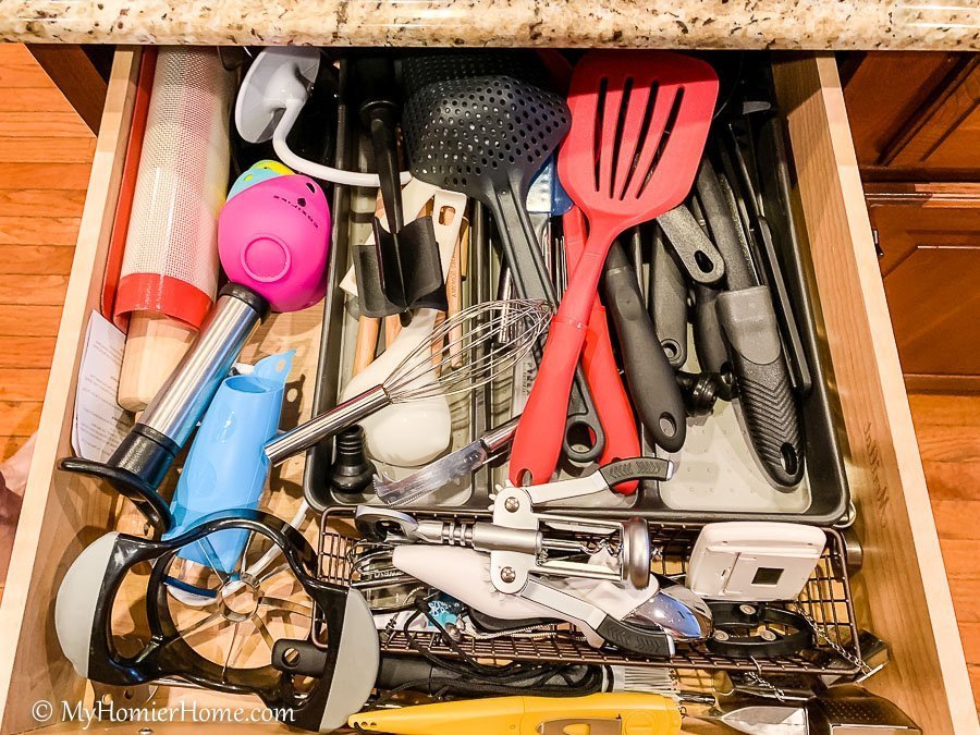 How to organize your kitchen cabinets using clear and simple strategies to tackle kitchen cabinet dysfunction without losing your mind. The extra utensil drawer before... yikes!