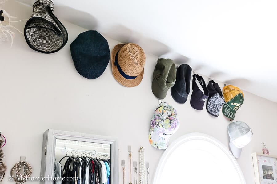 Organizing the master closet by getting hats on display.